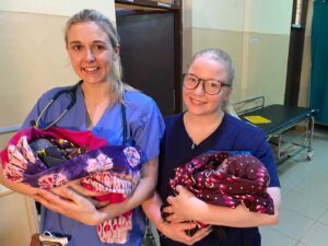 Two ladies holding new borns-St.Joseph-Medical Elective Interns-Tanzania Volunteers